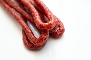 Pork or beef sausage, dry sausages, meat stick smoked close-up. Polish thin, long, dry sausage on a...