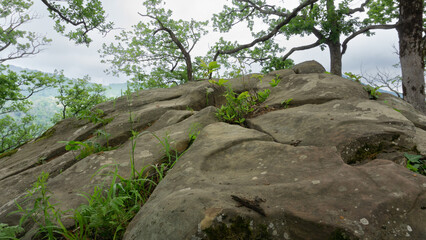 Mountain landscape with big stones and tree branches on the sides. Lazarevskoye, the end of a long route along the location of the Berendeyevo kingdom