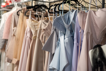 Fototapeta premium lot of party dresses hanging on hangers at market