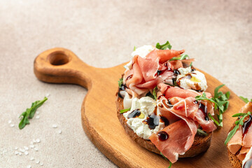 Open ham sandwiches, arugula and cream cheese. Appetizers. Food recipe background. Close up