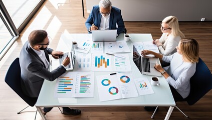High angle view of business people working together at meeting table in office