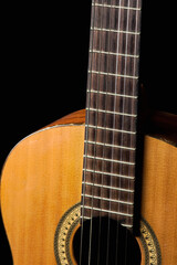 Fototapeta premium Acoustic guitar on a black background. Musical instrument