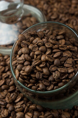Coffee beans in a glass jar on a black background