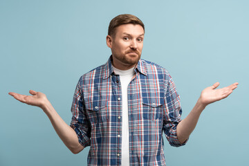 Man spreads hands to sides, not knowing answer. Young guy with kind of uncomprehending opened arms...