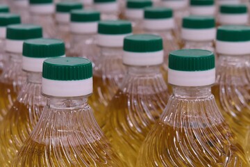Vegetable oil plastic bottles with green caps