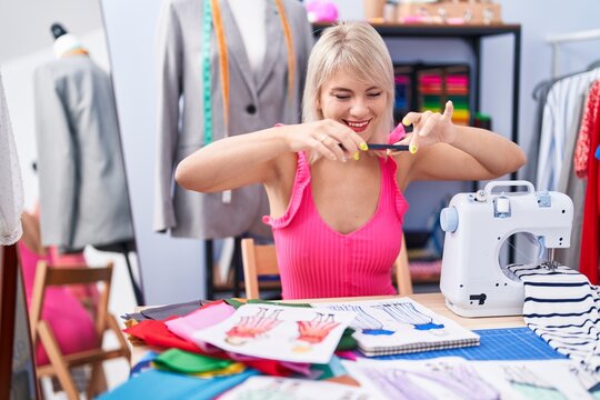 Young blonde woman tailor make photo by smartphone to clothing design at gaming room