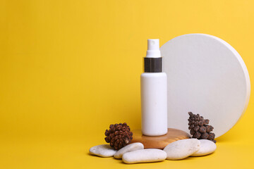 Nature composition of cosmetic spray bottle mockup with white round geometry, pines and spa stones. Display product and presentation