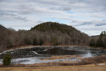 an icy pond in massachusetts wintertime