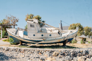 Obraz premium Abandoned Old Boat by the Shore Malia Beach - Crete - July - 2023