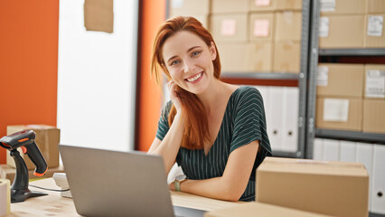 Young redhead woman ecommerce business worker using laptop smiling at office