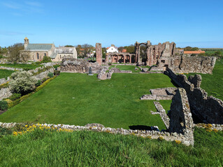 A sunny view across to St. Mary the Virgin Church and the ruins of Lindisfarne Priory on the Holy...