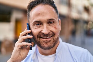 Young caucasian man smiling confident talking on the smartphone at street