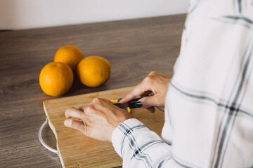 Vivid citrus fruits arranged, hand reaching in. Fresh, healthy, and enticing.