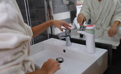 Woman hands from tap for washing hands. Personal hygiene and hand washing