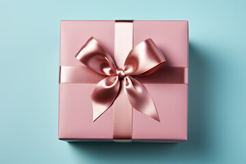 Pink gift box with bow on blue background, close up
