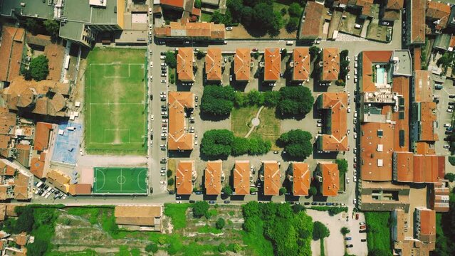 Aerial overhead shot of the residential buildings and sports facilities in Piacenza, Italy