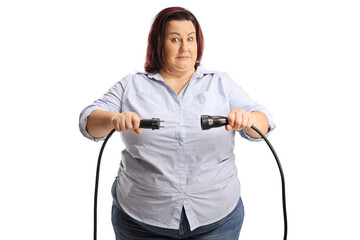 Scared corpulent woman unplugging cables