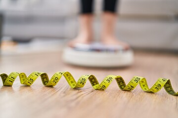 Young caucasian woman weighing at home