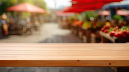 Naklejka na ściany i meble empty wooden table in modern style for product presentation with a blurred market place in the background