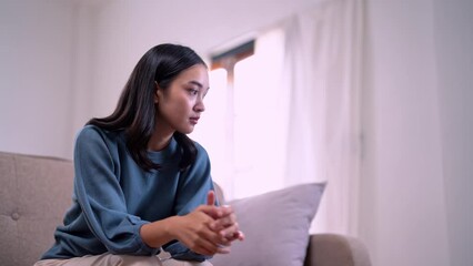 Absent-minded Asian female feeling lack of motivation or ideas wasting time at home unmotivated.