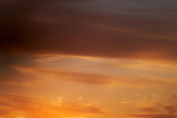 The setting sun created a stunning display of fiery orange and red colors in the evening sky as it disappeared below the horizon.