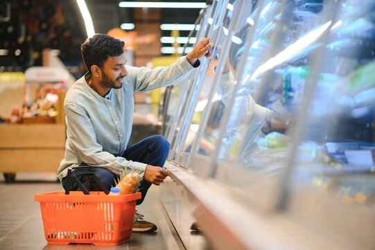 Portrait Of Handsome Young Indian Man Standing At Grocery Shop Or Supermarket, Closeup. Selective Focus.