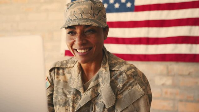 Soldier blowing kisses over a video call as she connects with her family from the military