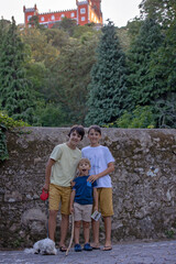 Family with children, siblings, visiting castle Pena in Sintra during family vacation summertime