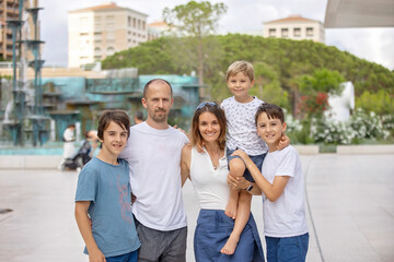 Beautiful portrait of young barefeet child, walking in Monaco, beautiful white terrace next to the beach