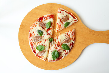 Tortilla Pizza with cheese, mushrooms and basil leaves on wooden board.