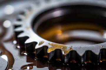A mesmerizing close-up showcasing the application of gear oil onto a metallic gear, meticulously creating a resilient shield that thwarts the menace of corrosion and the ravages of constant use.