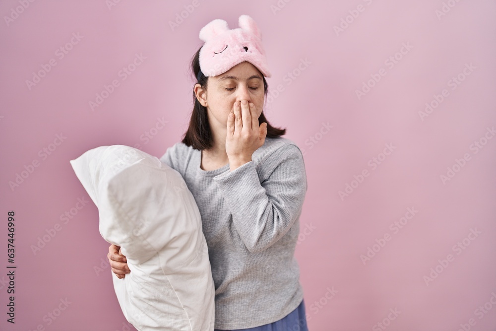 Sticker Woman with down syndrome wearing sleeping mask hugging pillow bored yawning tired covering mouth with hand. restless and sleepiness.