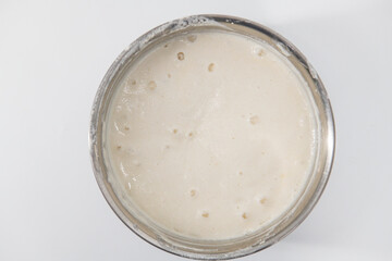 Selective focused image of fermented batter for idli and dosa in an isolated background. Idly and dosa batter in a bowl for fermentation, used to prepare the dosa and idli..