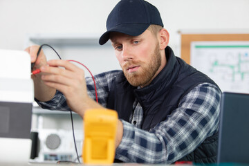 electrician checking an electric device