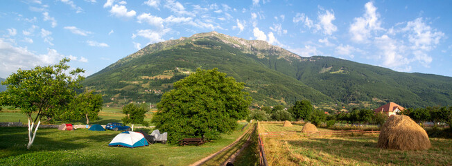 Camping in the Plav Valley in the mowed meadows in Montenegro - obrazy, fototapety, plakaty
