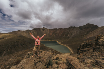Woman explorer takes photos of the great volcanic landscape of Nevado de Toluca, Mexico, while...