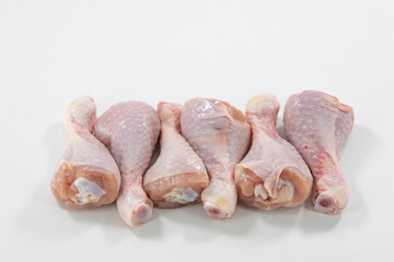 Fresh Raw chicken legs isolated on a white background. Raw chicken drumsticks with isolated. Close up shot of chicken leg cut isolated..