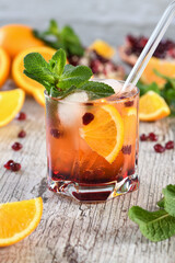  The cocktail is made from pomegranate and orange juice with tequila or gin, with the addition of tonic. Served in a glass with ice, orange slices with pomegranate and a sprig of mint. Cocktail recipe