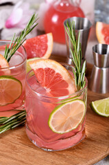 Pink Paloma Refreshing organic cocktail with grapefruit slice, lime and rosemary sprig in a glass cocktail red grapefruit with tonic
