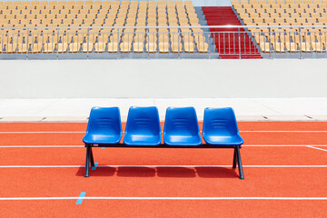 Blue reserve chair bench for staff, coach, substitutes players bench in outdoors sport stadium