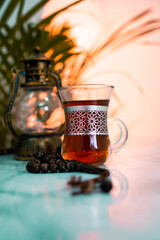 Iftar food concept image, Black tea with lantern lamp on the background