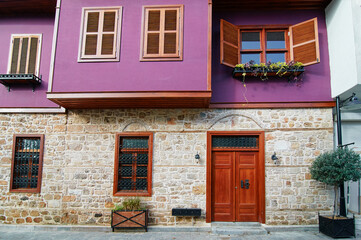 Purple old building with wooden vintage door and windows.