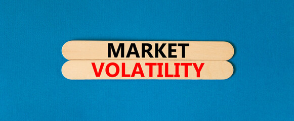 Market volatility symbol. Concept words Market volatility on beautiful wooden stick. Beautiful blue table blue background. Business market volatility concept. Copy space.
