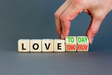Love today not tomorrow symbol. Businessman turns wooden cubes and changes word Love tomorrow to Love today. Beautiful grey background. Business and love today not tomorrow concept. Copy space.
