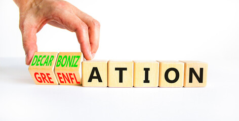 Decarbonization or greenflation symbol. Concept words Decarbonization Greenflation on cubes. Beautiful white background. Businessman hand. Business decarbonization greenflation concept. Copy space.