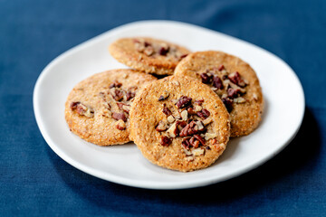 White plate with walnut cookies - side view
