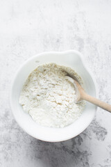 All purpose flour in a white bowl, baking flour in a large bowl