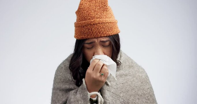Sneeze, sick woman and allergies with blowing nose in tissue and toilet paper from virus. Studio, white background and female person with disease and cough from health and wellness issue with cold