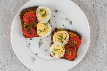 Sandwiches with vegetables and boiled eggs. Diet sandwiches with herbs and spices on a plate.