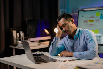 Asian businessman or employee feels like going crazy after hard work and overtime. Asian Male employee who is stressed and tired from working overtime late at night.